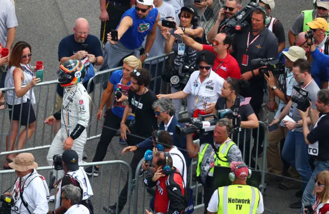 Alonso walks back to the garage