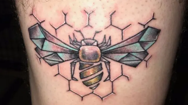 Tattoo of bee on calf