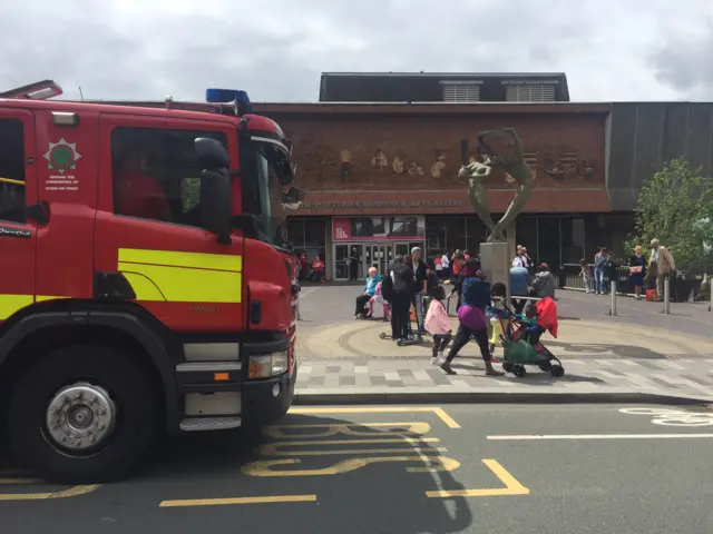 Fire engine and people outside museum