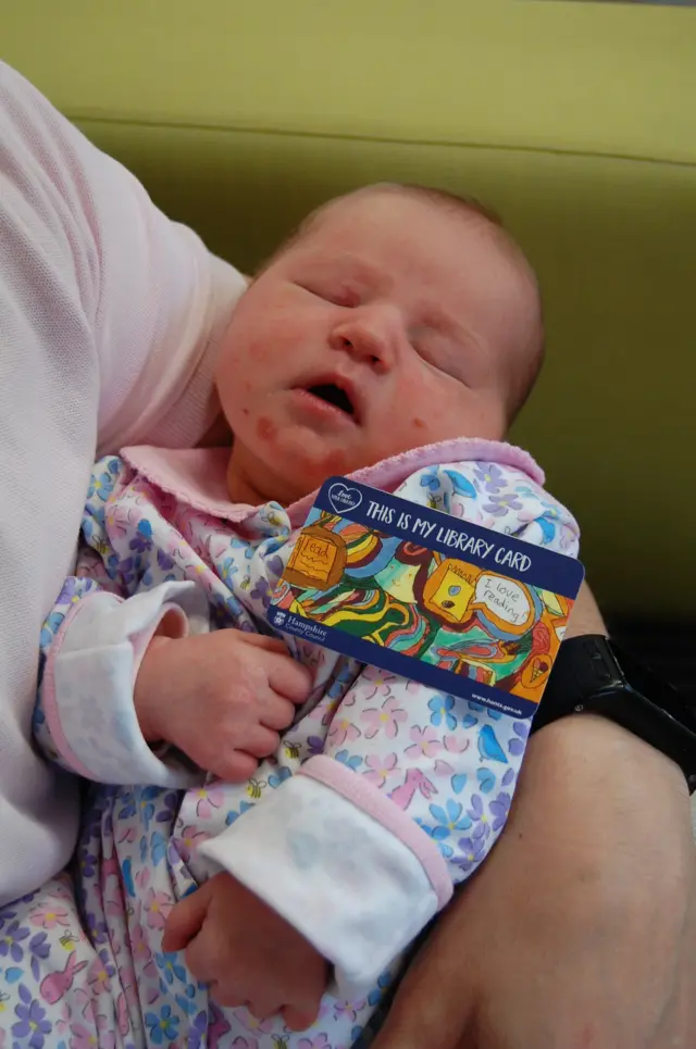 Baby with library card