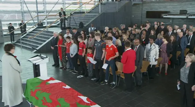 The family leads the Welsh anthem