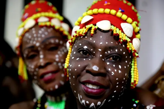 Members of the Congolese Cultural Dance Group pose for photographs as they get ready backstage before they present "Ballet National Du Congo" in Bhopal, India