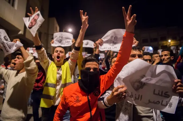 Demonstrators hold pictures of Nasser Zafzafi, leader of the Rif region"s protest movement, during a demonstration against corruption, repression and unemployment in the northern city of al-Hoceima on May 30, 2017