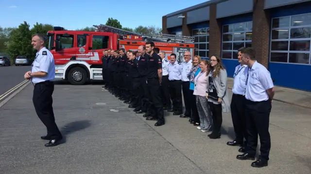 Firemen outside station