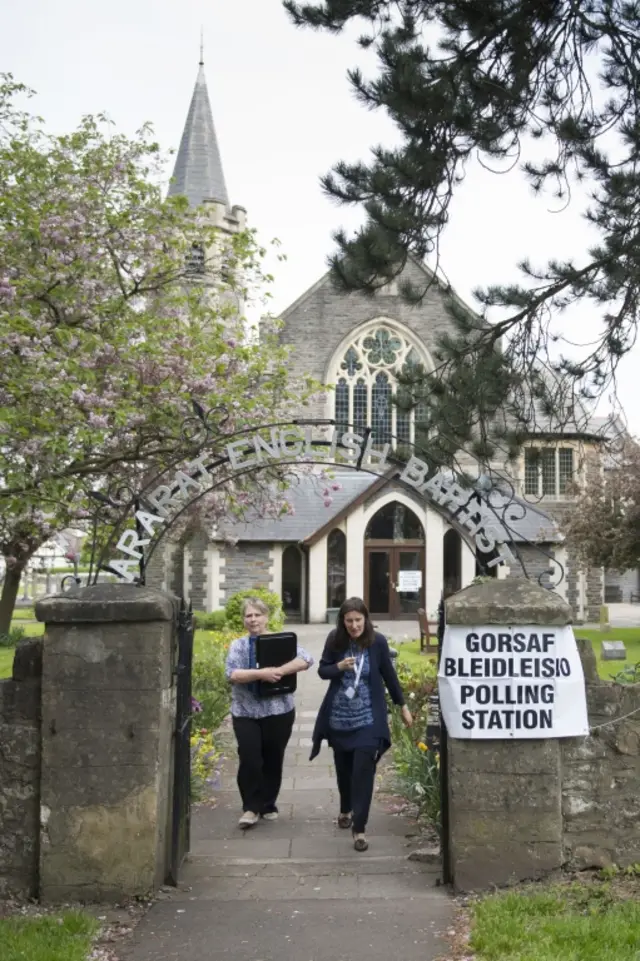 Two women leave a polling station at the Arat Baptist Church during the local council elections in Whitchurch, Cardiff