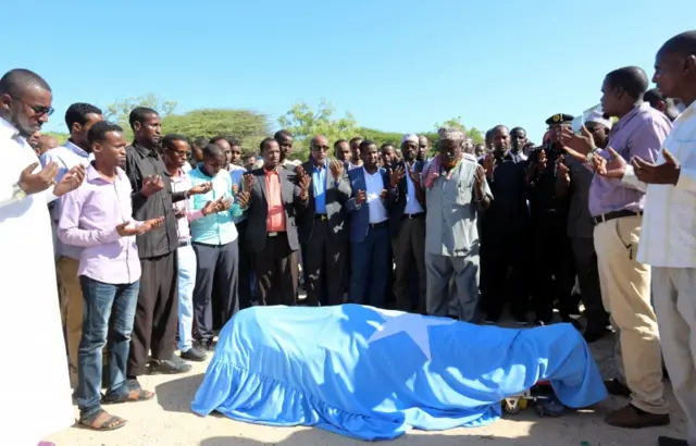 Relatives and government officials attend prayers for public works minister, Abbas Abdullahi Sheikh Siraji who was shot and killed in Somalia"s capital Mogadish