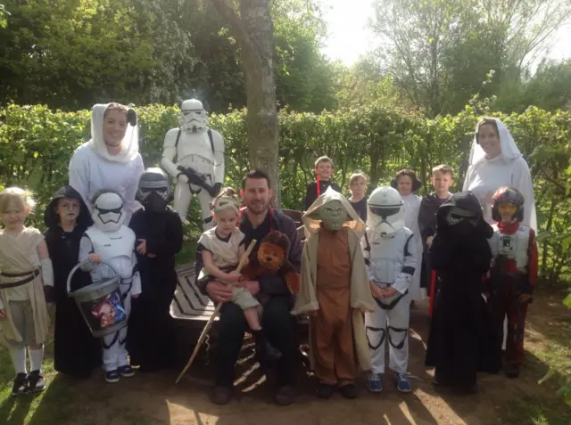 Pupils in Star Wars costumers, with Nell and Tristan Cork seated with a Chewbacca toy