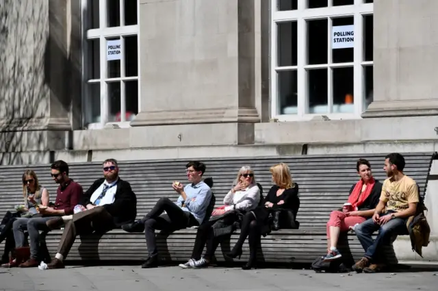 People sitting outside polling station in Manchester