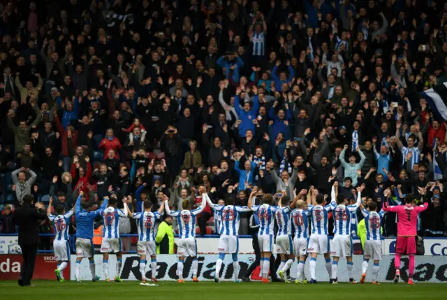 Huddersfield Town players celebrate with fans