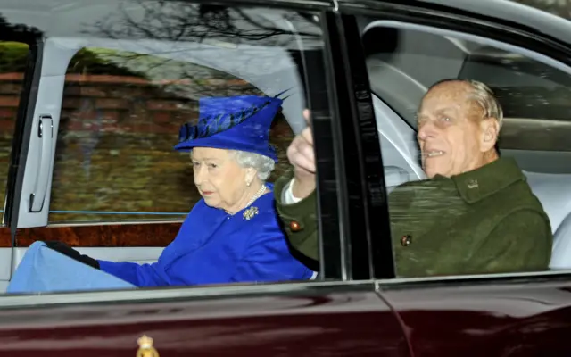 The Queen, with Prince Philip in the back seat of a car