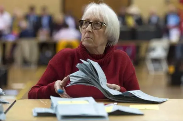 A woman counts ballot papers at Llanishen Leisure Centre in Cardiff