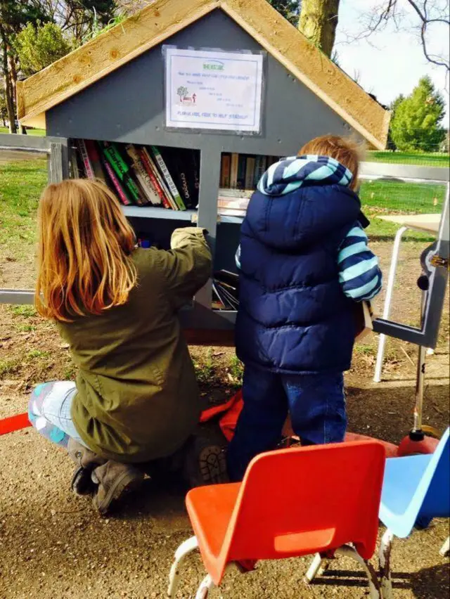Children in front of the Little Free Library