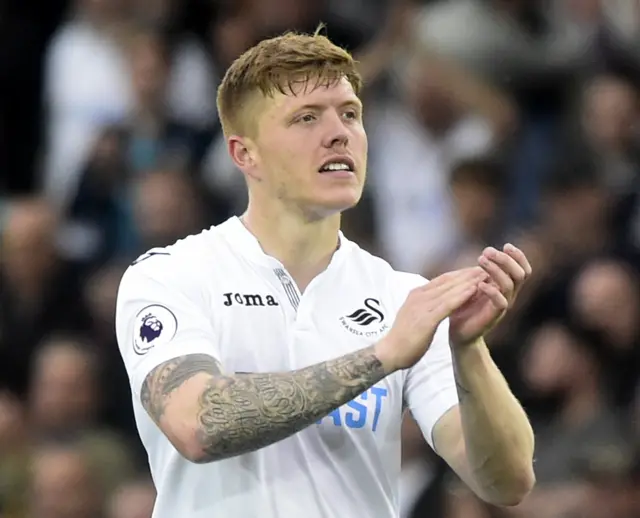 Alfie Mawson applauds the fans