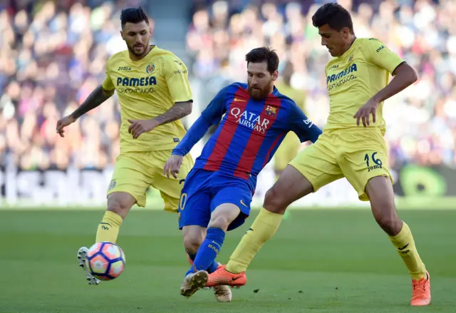 Barcelona's Messi vies with Villareal's Hernandez and Soriano