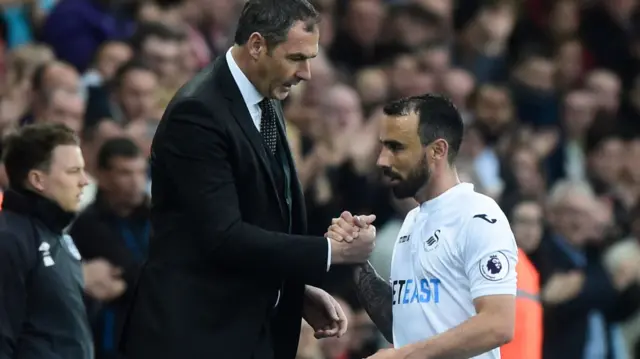 Leon Britton shakes hands with Paul Clement