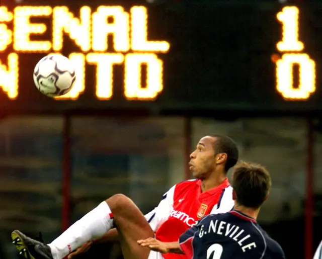 Thierry Henry takes on Gary Neville