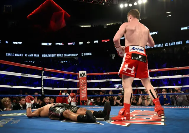 Saul Alvarez stands over Amir Khan