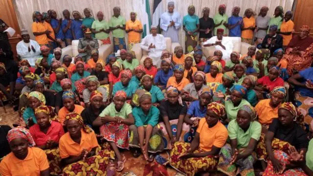 Nigeria's President Muhammadu Buhari applauds as he welcomes a group of Chibok girls, who were held captive for three years by the millitant group Boko Haram, in Abuja, Nigeria, May 7, 2017