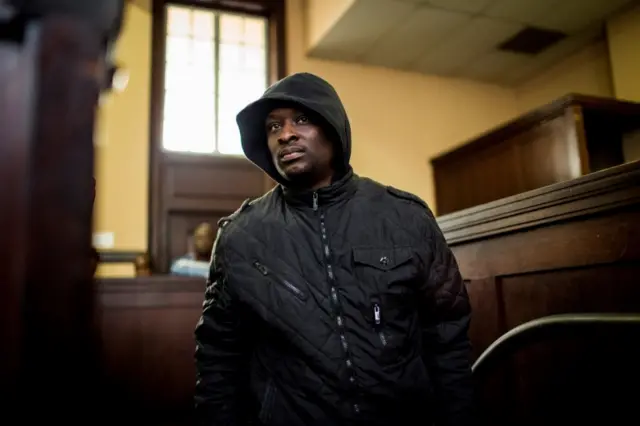 Elvis Ramosebudi suspected for planning the assassinations of 19 South African politicians, prominent business people and employees of state-owned entities looks on at the Johannesburg Magistrate Court on April 28, 2017