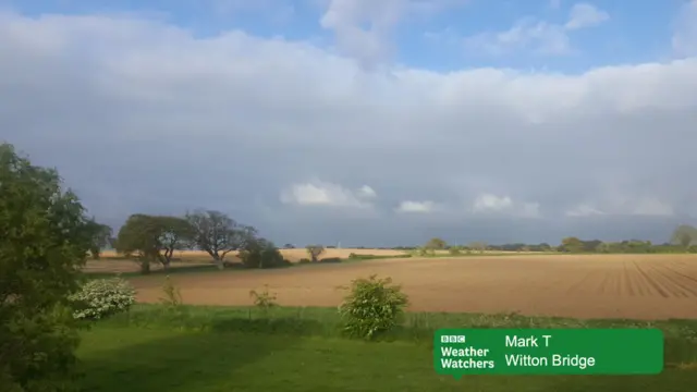 Dark clouds over farmland