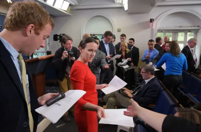 Lyndsey Walters arrived in the briefing room to hand out copies of Trump's letter