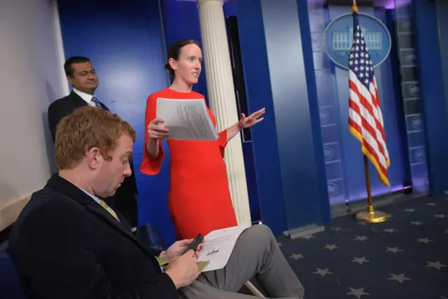 Lyndsey Walters arrived in the briefing room to hand out copies of Trump's letter