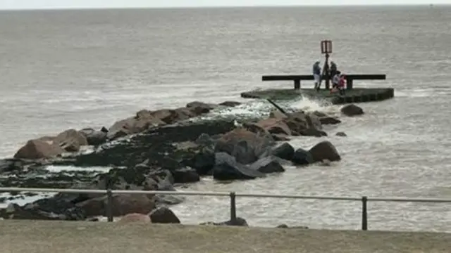 Family on rocks at Ness Point