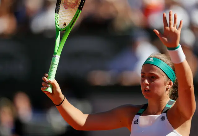 Jelena Ostapenko holds her hands up