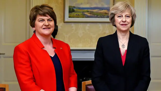 DUP leader Arlene Foster and Theresa May stand side by side in 2016