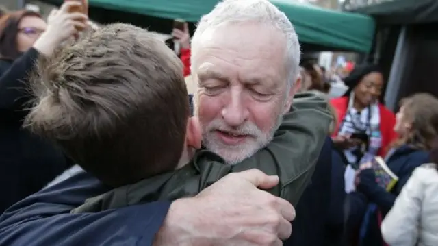 Corbyn hugs a boy