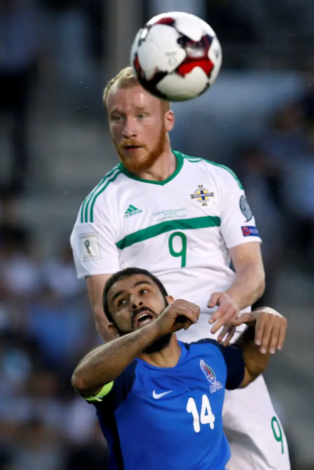 Liam Boyce heads the ball