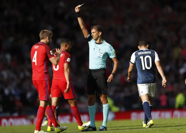 Eric Dier is shown a yellow card