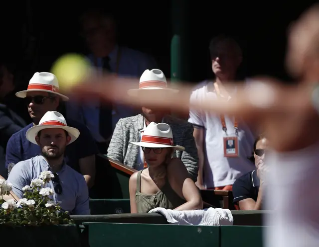 Spectators watch Simona Halep serve