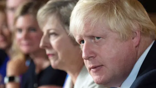 Boris Johnson, with Theresa May in the background