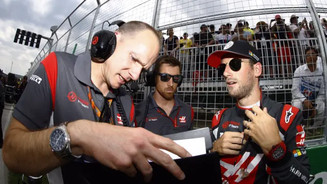 Romain Grosjean talks to his engineers before the race