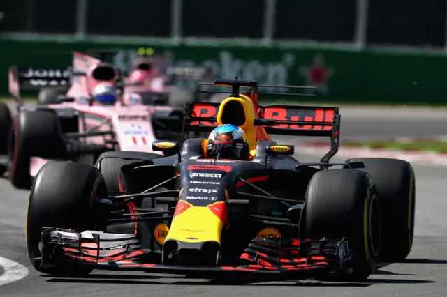 Daniel Ricciardo is chased by the Force India cars