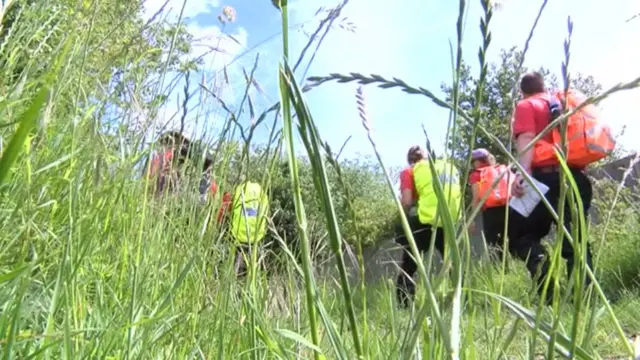 Search teams with reflective backpacks