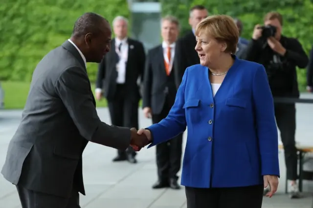 German Chancellor Angela Merkel greets Chairman of the African Union Alpha Conde upon his arrival at the Chancellery on June 12, 2017 in Berlin, Germany