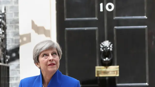 Prime Minister Theresa May pictured in front of 10 Downing Street on 9 June after she traveled to Buckingham Palace for an audience with Queen Elizabeth II following the General Election results.