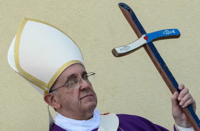 ope Francis, holding with a cross made from the wood of rickety fishing boats that migrants typically arrive on, leads a mass during his visit to the island of Lampedusa, a key destination of tens of thousands of would-be immigrants from Africa, on July 8, 2013.