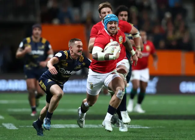 Jack Nowell of the Lions is tackled by Kayne Hammington of the Highlanders