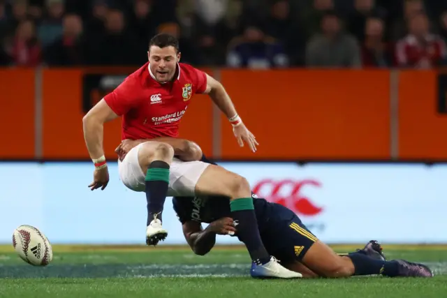 Robbie Henshaw of the Lions is tackled by Malakai Fekitoa