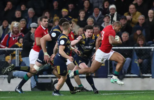 Jonathan Joseph of the Lions breaks away to score his team"s first try