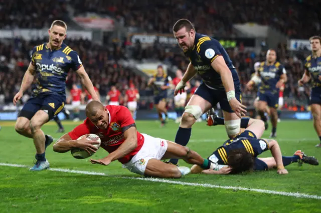 Jonathan Joseph of the Lions dives over to score his team"s first try