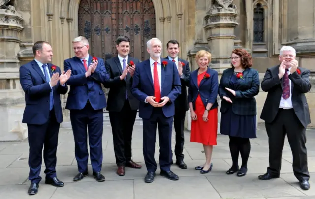 Labour leader Jeremy Corbyn welcomes Scottish Labour MPs outside the Commons