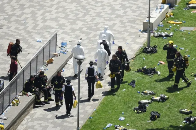 Forensic teams arrive near the burning 24 storey residential Grenfell Tower