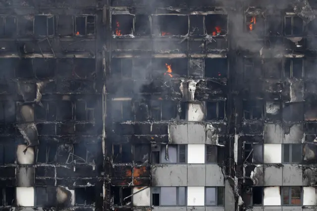 Fires continued to burn in the middle of the tower more twelve hours later