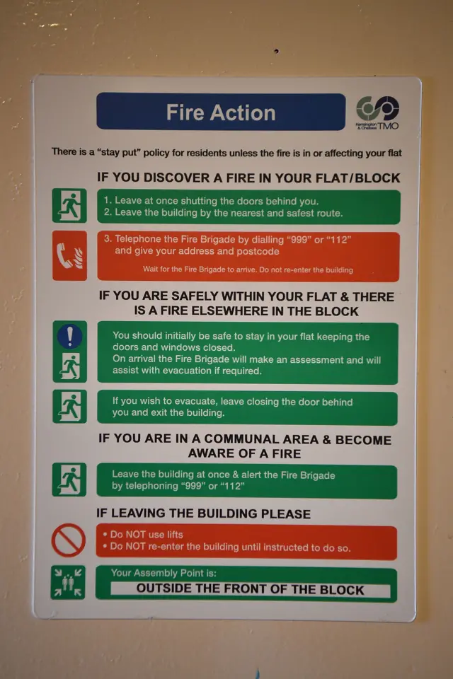 A fire action sign displayed inside a block near the 24 storey residential Grenfell Tower.