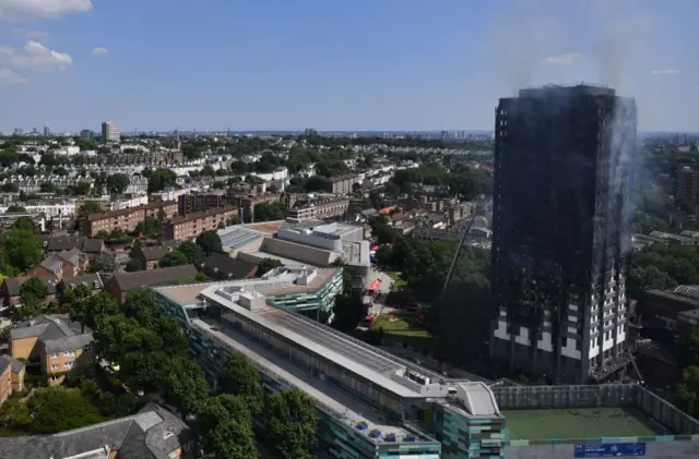 Grenfell Tower smoulders after a fire ripped through the building in west London