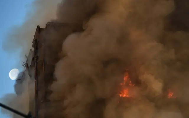 The fire in Grenfell Tower continued to burn as dawn broke